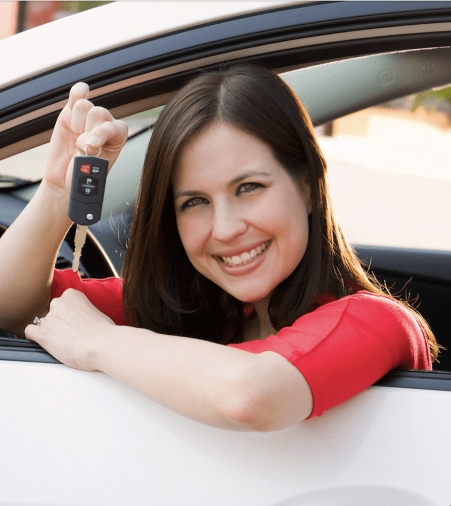 Woman holding keys from a leased a car