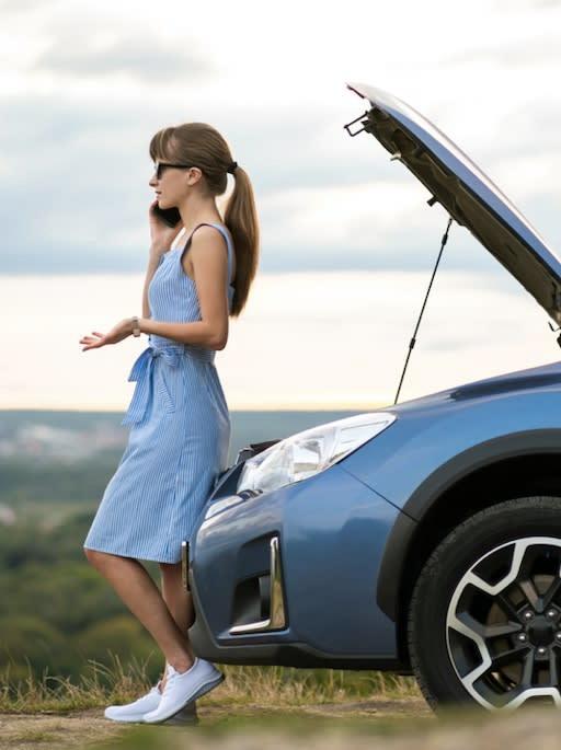 A woman calling to roadside assistance for car troubleshooting