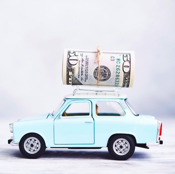 A toy mini-car with a 50 dollar note on the top