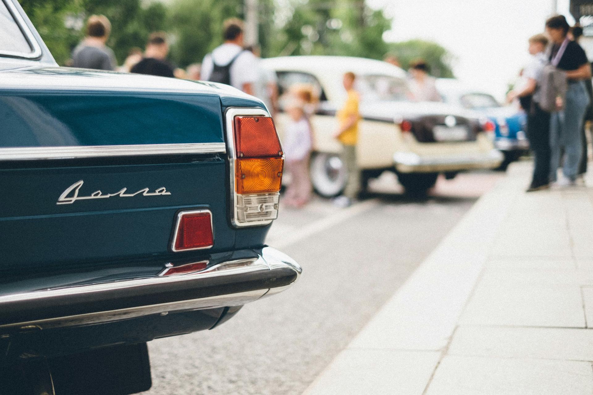 The back of a vintage car in a parking lot