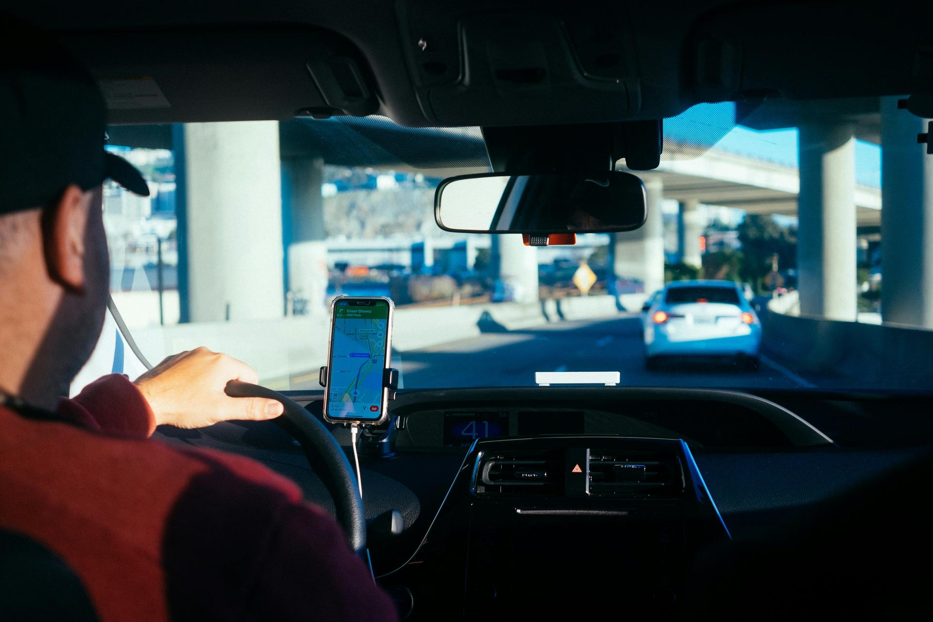Man driving in traffic with GPS map